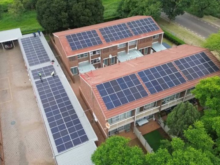 Aerial view of rooftop solar panels on a block of flats